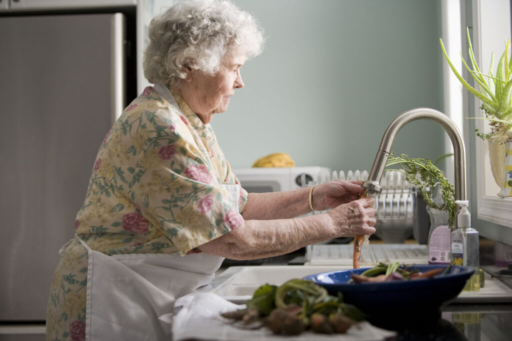 elderly-woman-washing-produce