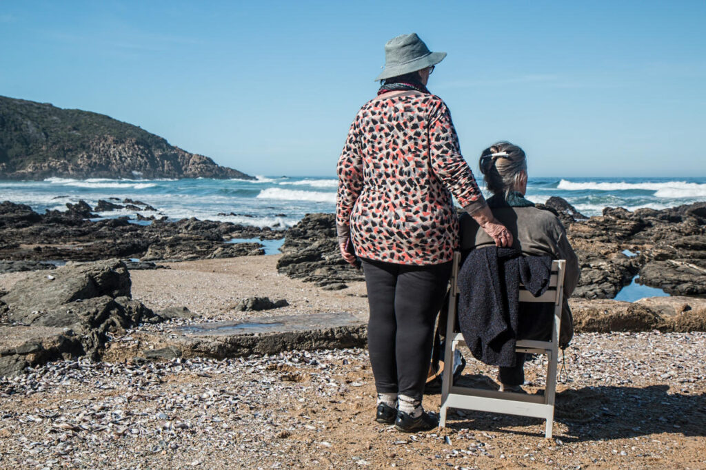 elderly mother and daughter on the beach