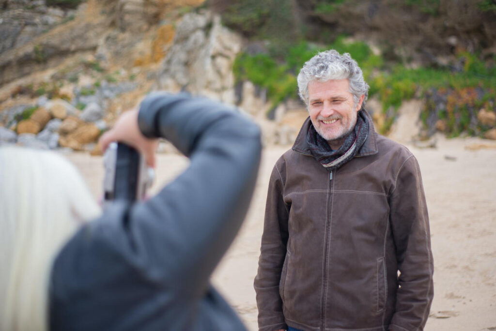 senior-couple-taking-photo-on-beach